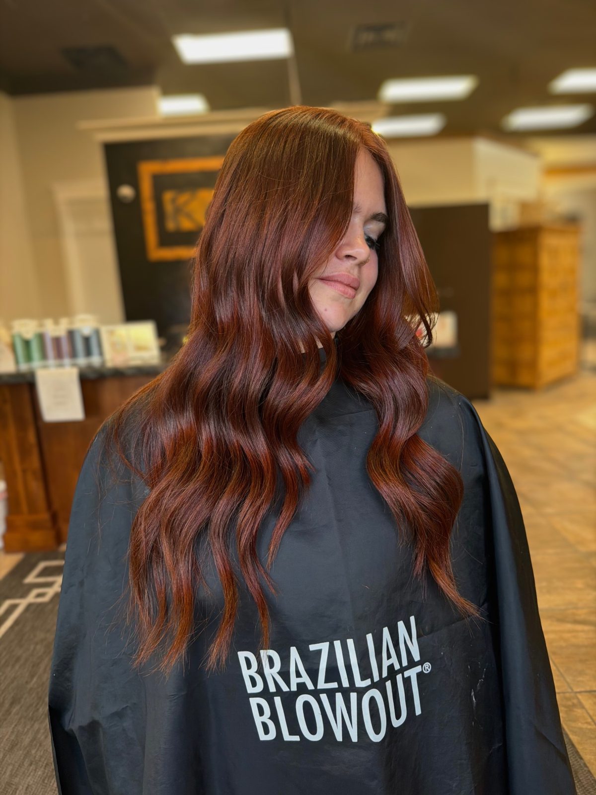Deep copper red hair with curtain bangs and glossy waves — Logan, UT