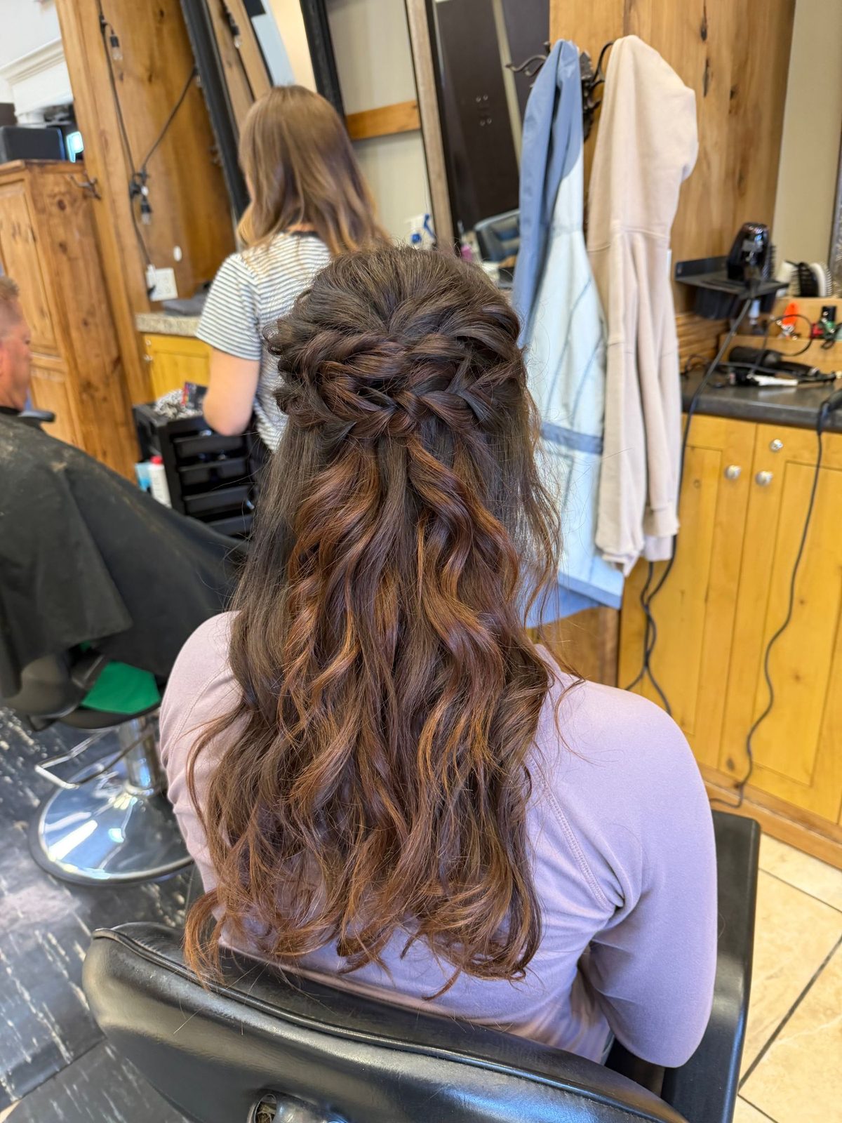 Half-up twisted braid crown with soft curls on brunette balayage