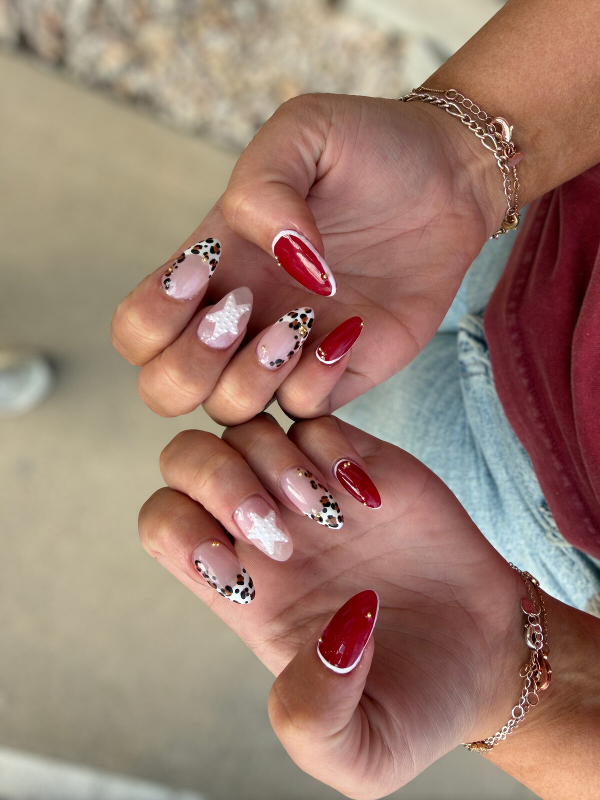 Glossy red almond nails with leopard print French tips and white star accents — Logan, Utah