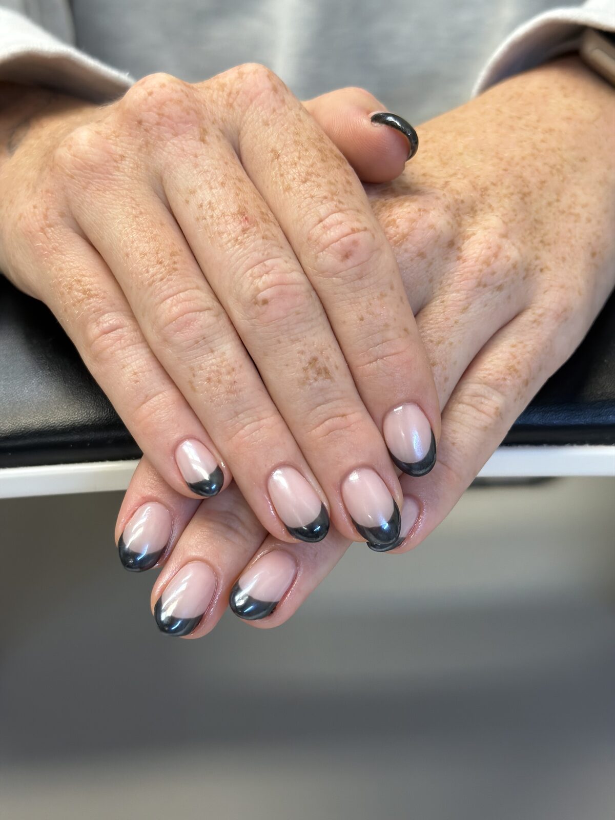 Charcoal chrome French tips on short round nails