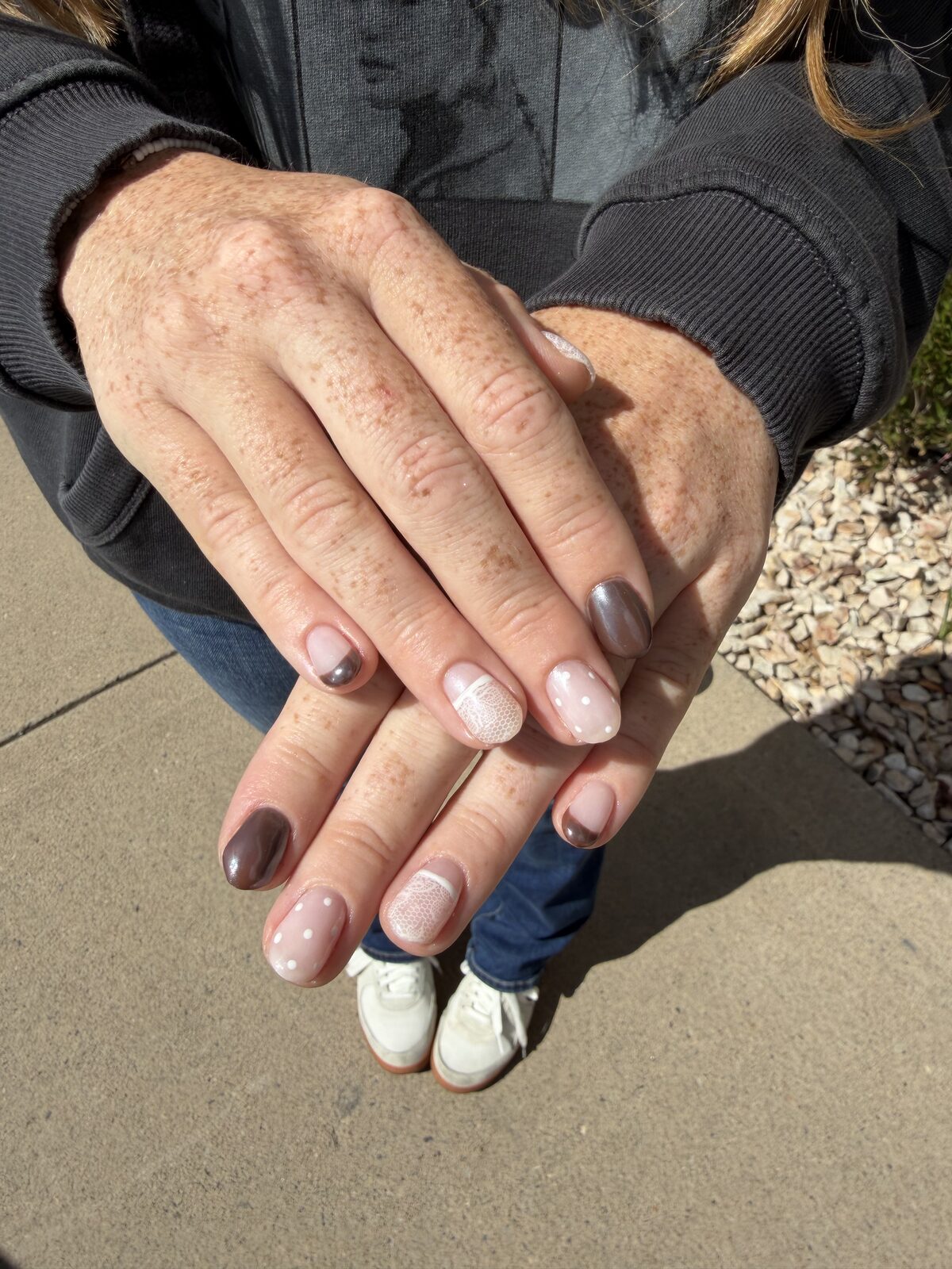 Neutral nail mix with taupe, mauve, polka dots, and a sweater-knit accent — Logan, UT