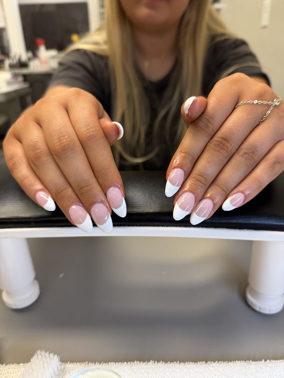 Classic white French tips on long almond nails
